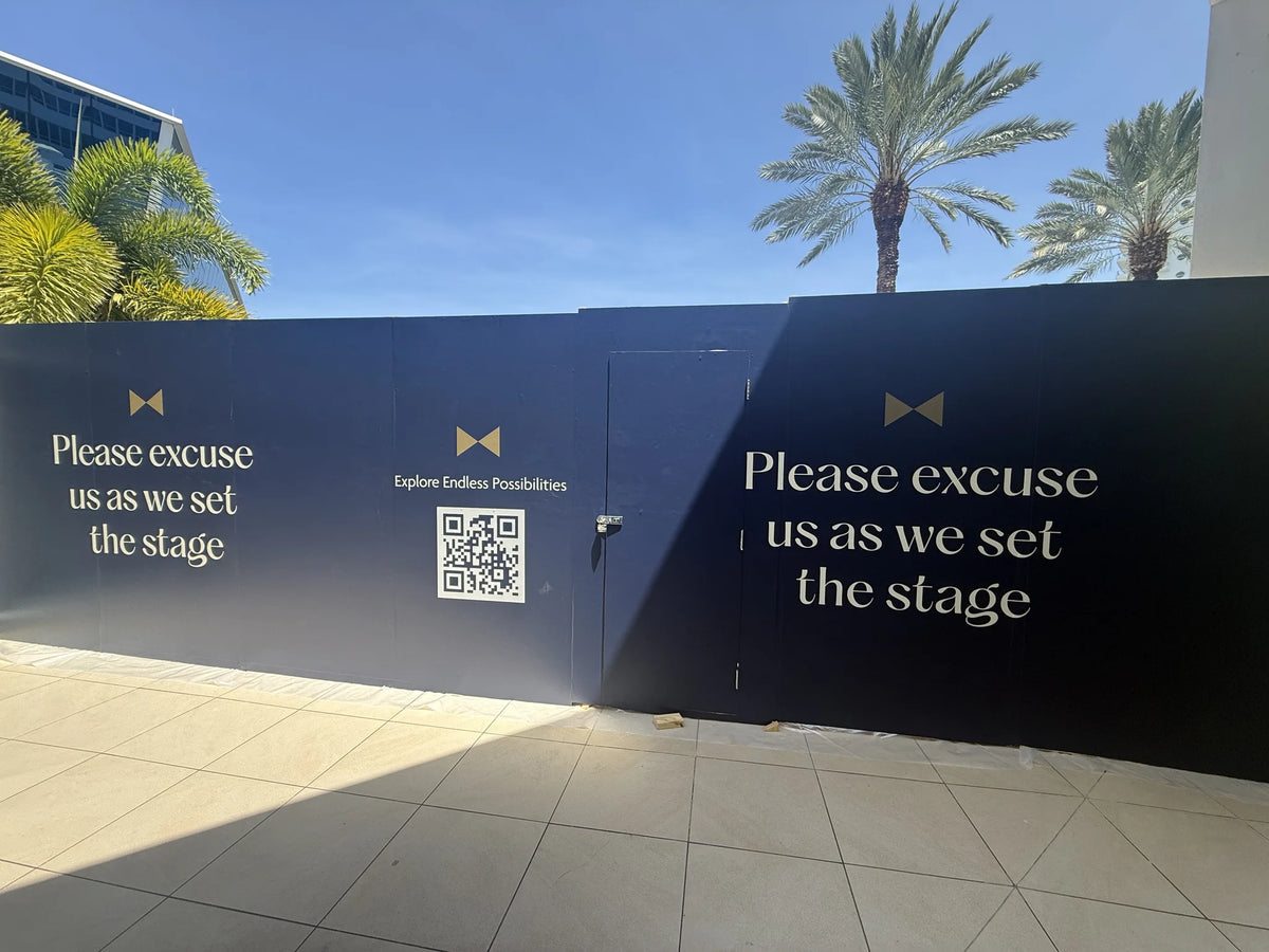 Branded construction hoarding with gold typography
