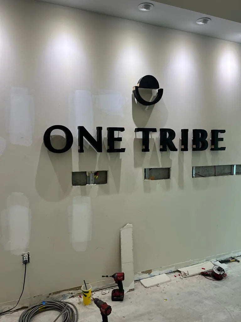 One Tribe dimensional wall logo in a finished interior